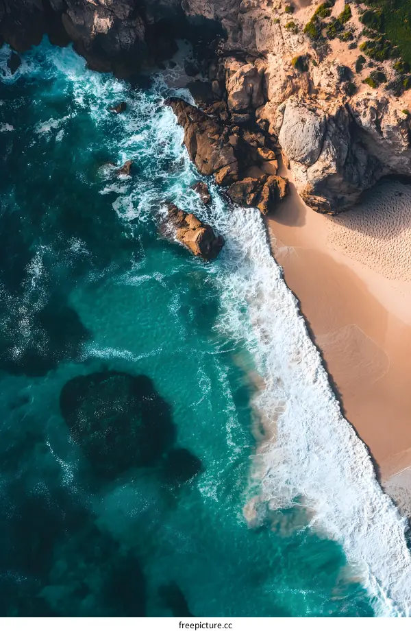 Aerial View of Turquoise Ocean Waves Crashing on Sandy Beach
