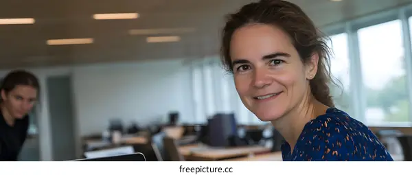 Smiling Woman in a Modern Office Setting