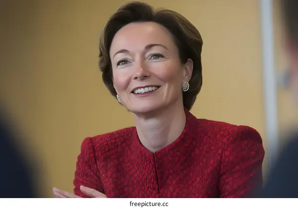 Close Up Portrait of a Smiling Woman in a Red Blazer