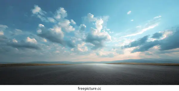 Empty Asphalt Road Under a Vast Sky