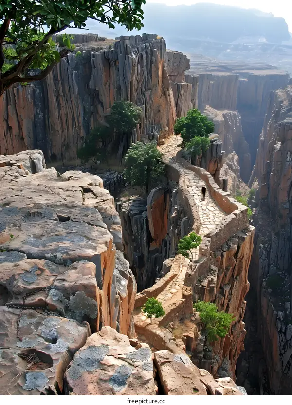 A stone path winds through a narrow canyon