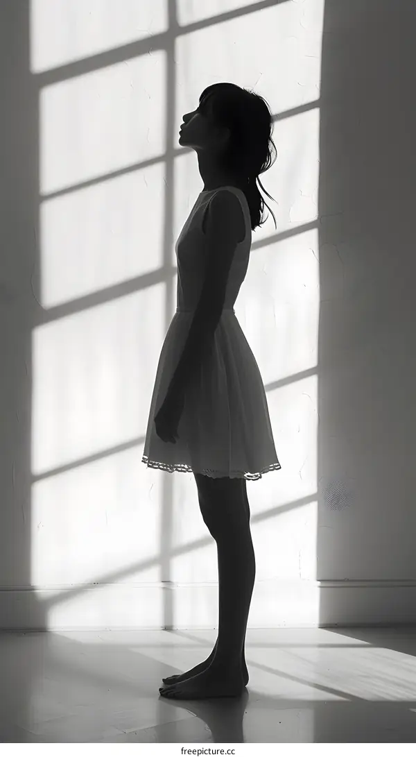 Woman in White Dress Standing in Window Light