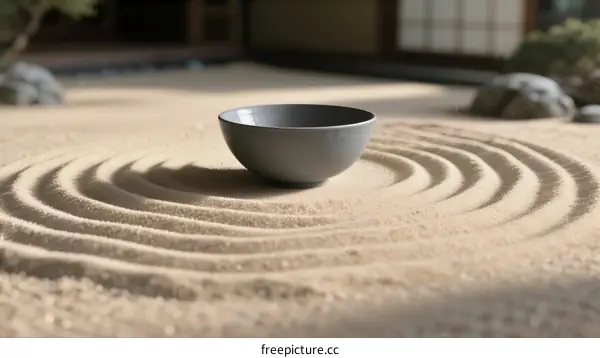 A Gray Bowl Placed on Sand with Circular Patterns in a Zen Garden