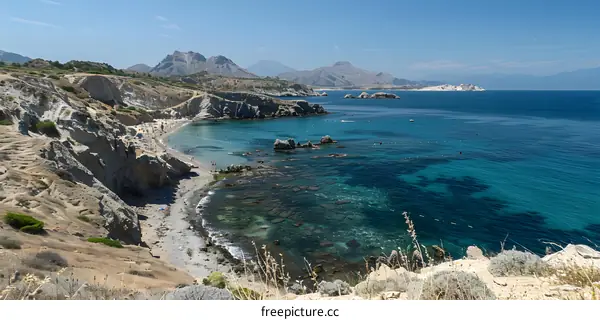 Secluded beach with crystal clear water and mountains in the distance