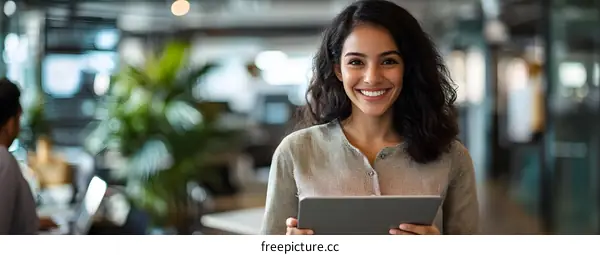 Smiling Hispanic Woman Using Digital Tablet in Modern Office