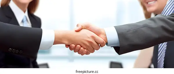 Businessmen shaking hands agreement deal success