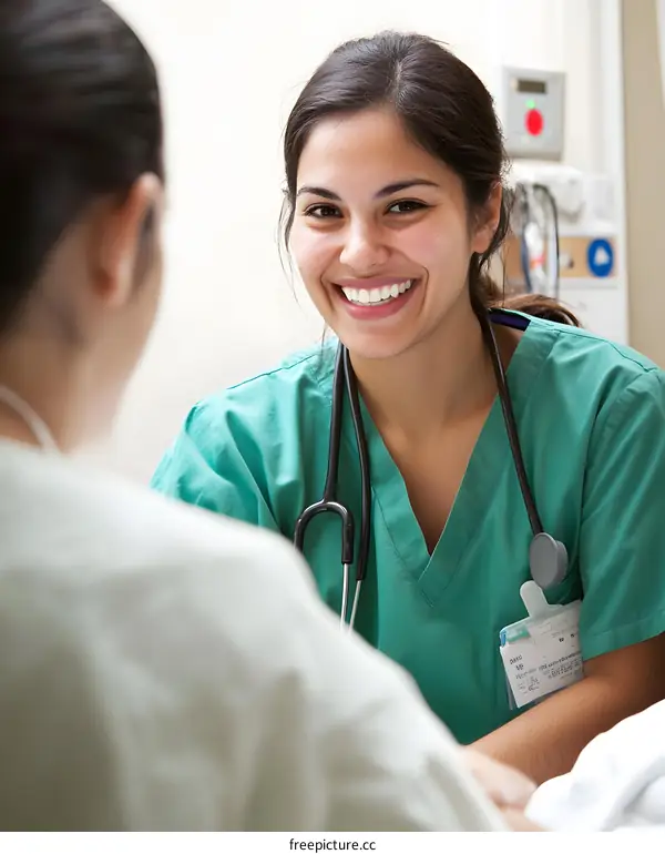 Smiling Female Doctor Wearing Scrubs With Stethoscope Talking To Patient In Hospital