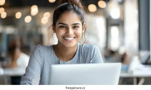 Young Woman Working on Laptop in Cafe