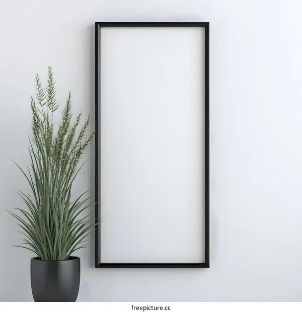 Blank Frame with Green Plant on White Wall