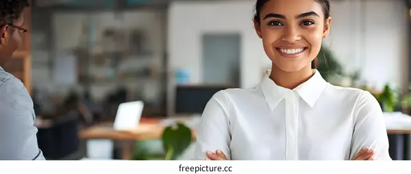 Smiling Woman with Arms Crossed in Modern Office