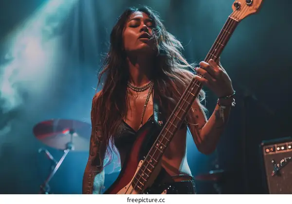 Asian female bass player performing on stage