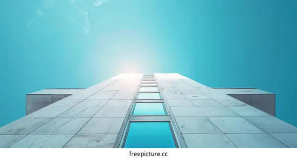 Modern Skyscraper Against Blue Sky and White Clouds