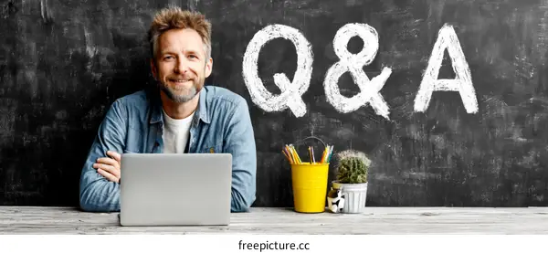 Man Working on Laptop with Q&A Background