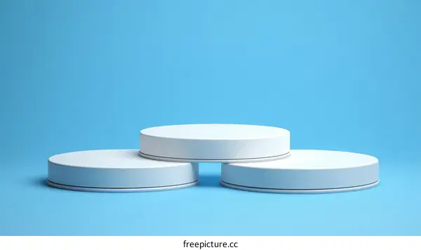 Three White Round Platforms on Light Blue Background