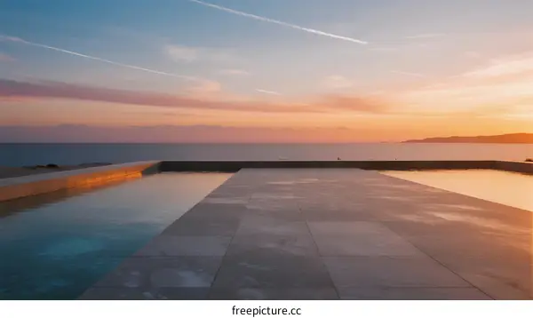 Stunning sunset view with infinity pool by the sea
