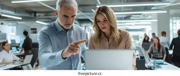 Business Coworkers Discussing Project on Laptop
