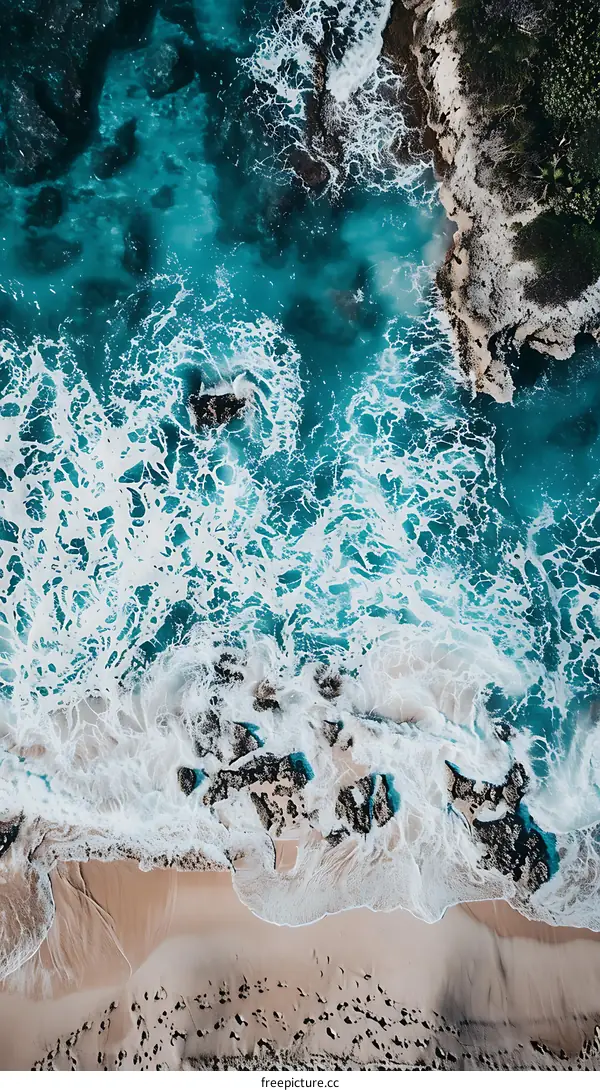 Aerial View of Ocean Waves Crashing on Sandy Beach