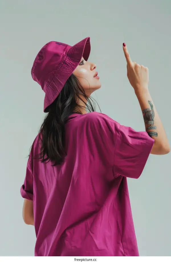 Portrait of a young woman wearing a bucket hat and a pink t-shirt