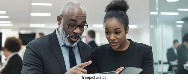 Two Business Professionals Discussing Business on Tablet