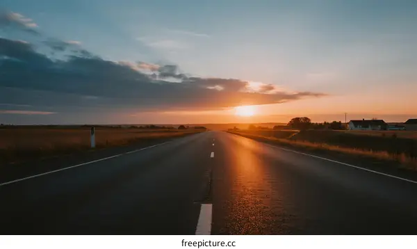 The beautiful sunset over an empty highway stretching into the distance