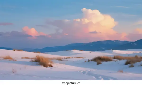 Stunning White Sand Dunes Under Fluffy Clouds at Sunset