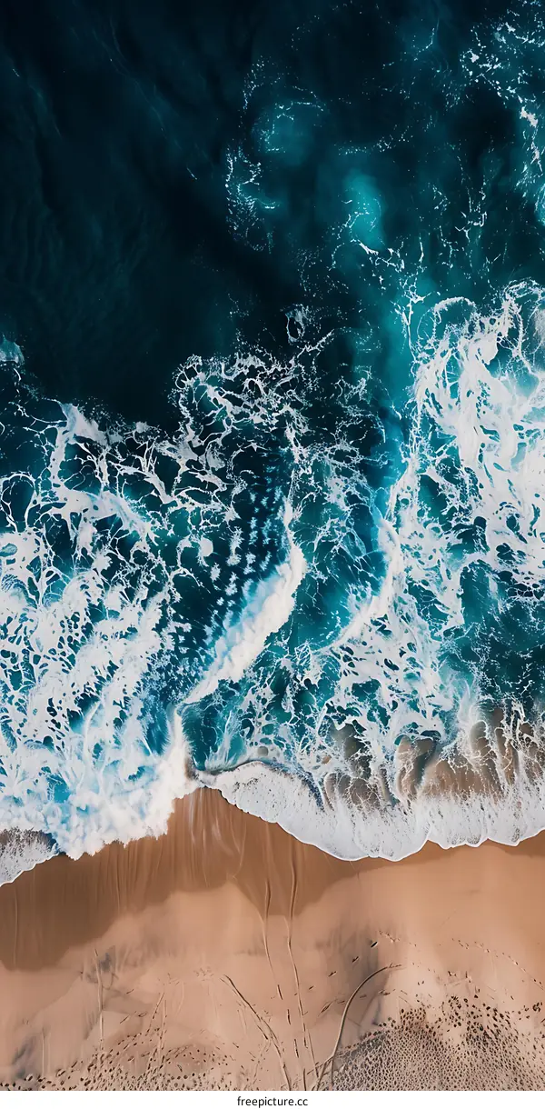 Aerial View of Ocean Waves Crashing on Sandy Beach