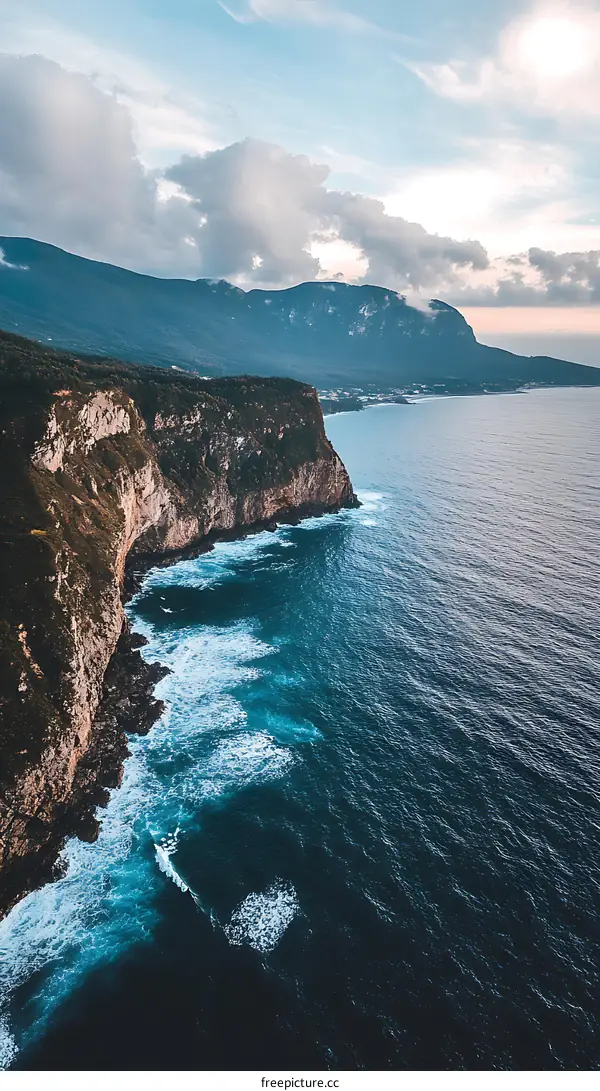 Aerial View of Rocky Coastline with Ocean Waves