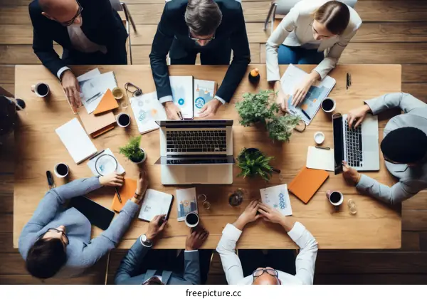 A group of people sitting around a table having a meeting