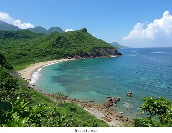A beautiful beach with green hills and blue water