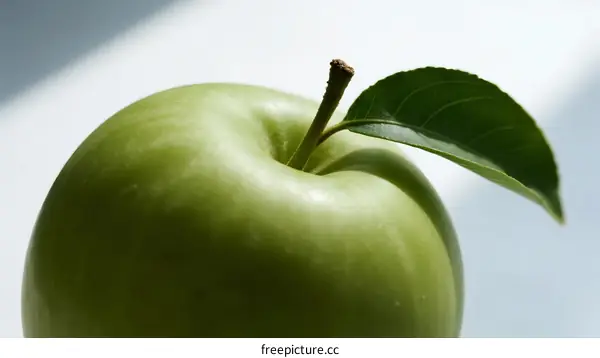 Fresh Green Apple with Leaf on White Background