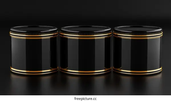 Three Elegant Black Cylindrical Objects with Golden Accents