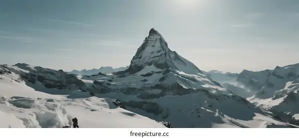Matterhorn peak with snow-covered slopes under clear sky