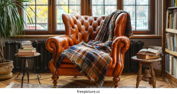 A comfortable reading chair with a warm blanket
