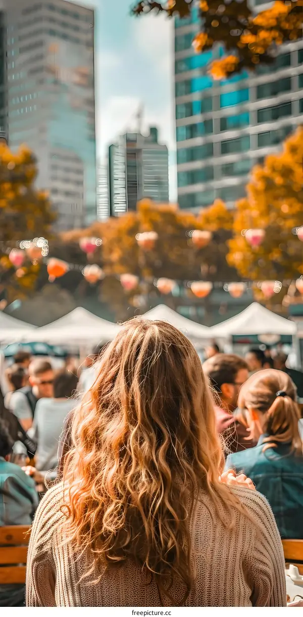 Woman with Curly Hair in Front of a City Skyline