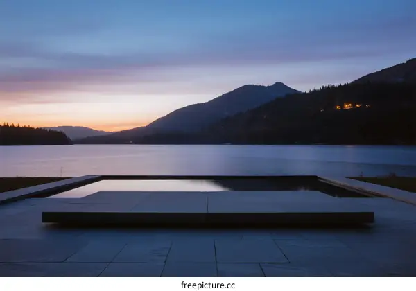 Serene sunset view of a lake with a modern platform in the foreground
