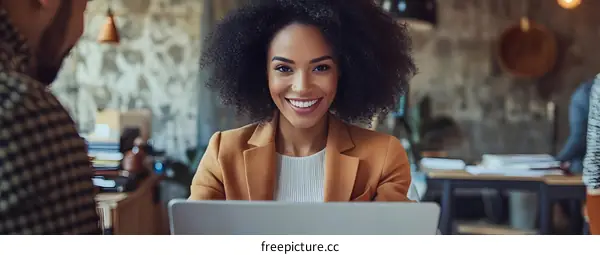 Smiling African American Businesswoman Using Laptop in Office