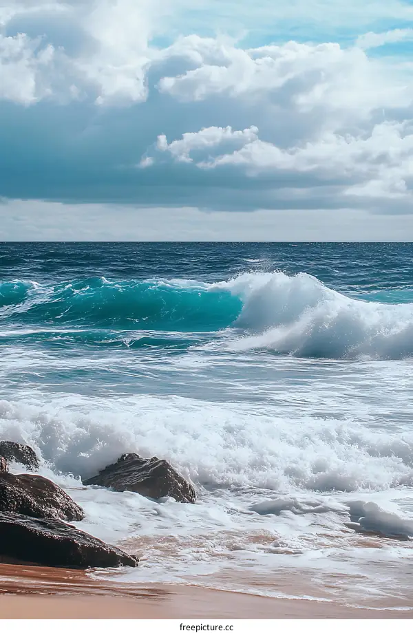 Ocean Waves Crashing on the Shore with Blue Sky and White Clouds