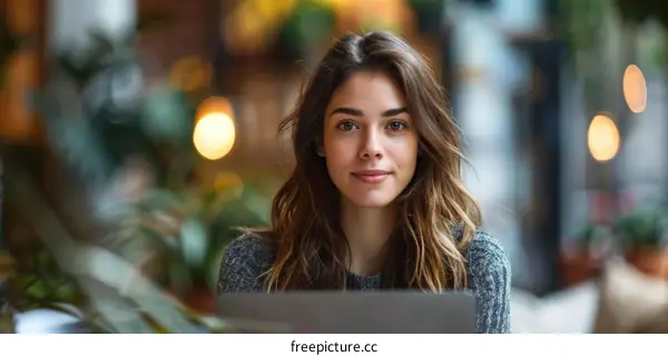Portrait of a young woman sitting in a cafe and looking at the camera