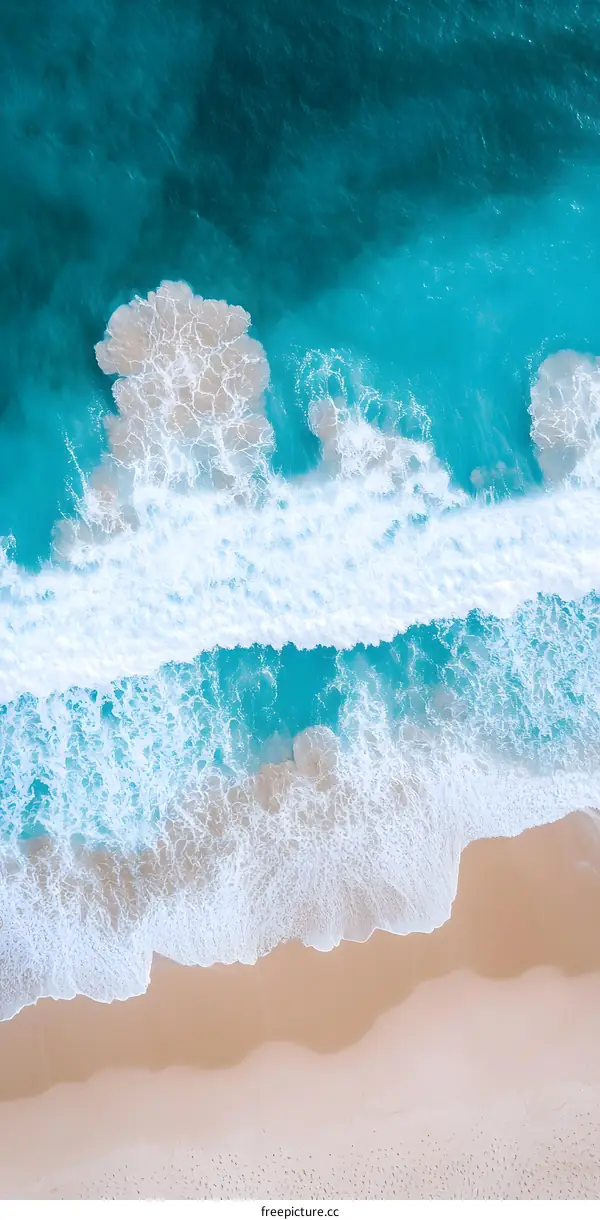 Aerial View of a Blue Ocean and White Waves Crashing on a Sandy Beach