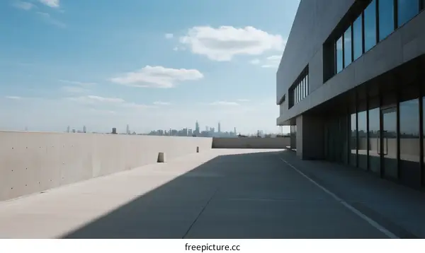 Modern concrete building with city skyline view from rooftop