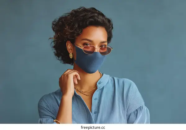 Woman Wearing Mask and Sunglasses in Studio
