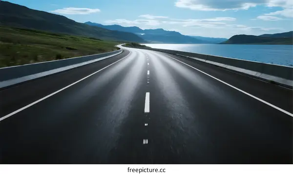 A long highway stretching through scenic natural landscapes