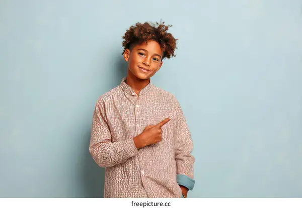 Smiling Boy in a Striped Shirt Pointing