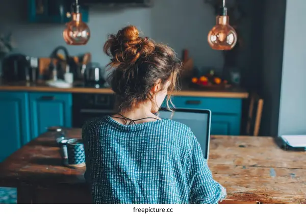 Woman working from home in a cozy kitchen