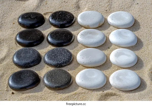 Black and white stones on sand