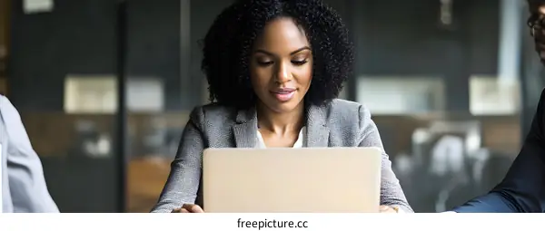 African American Woman Working on Laptop in Office