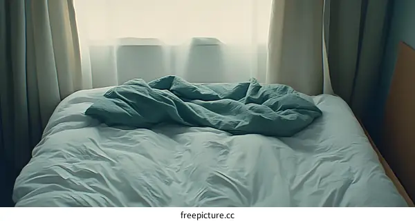White and Grey Bed Sheets on a Bed