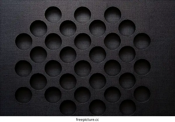 Abstract Pattern of Circular Holes on Dark Surface