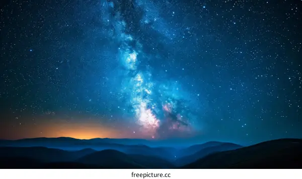 Amazing view of the night sky full of stars and a bright milky way over the mountains