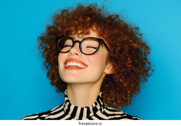 Smiling Woman with Curly Hair and Glasses